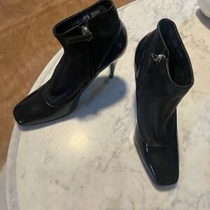 Brand Giuseppe black leather, patent booties Size 7 1/2 . Side zip. Silver heel